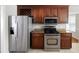Bright kitchen boasts stainless steel appliances and dark wood cabinetry at 6275 Cheatham Lake Nw Dr, Acworth, GA 30101