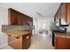 Bright kitchen features tile floors, granite countertops, stainless steel appliances, and stylish backsplash at 6275 Cheatham Lake Nw Dr, Acworth, GA 30101
