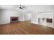 Living room with fireplace, wood floors and view into the kitchen at 6275 Cheatham Lake Nw Dr, Acworth, GA 30101