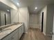 The primary bathroom features a dual sink vanity, granite countertops, and a separate shower and bathtub at 25 Yellow Brick Way, Covington, GA 30014