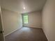 Bedroom features neutral walls, carpet, a window with natural light, and a ceiling light at 25 Yellow Brick Way, Covington, GA 30014