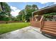 Expansive backyard featuring a wooden deck with a gazebo, lush green lawn, and mature trees at 4205 Jeri Lynn Ct, Tucker, GA 30084