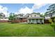 Full backyard view, highlighting the house, yard, deck, and mature trees at 4205 Jeri Lynn Ct, Tucker, GA 30084