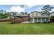 Large backyard showcases a home with a deck, sunroom, manicured lawn, and privacy fence at 4205 Jeri Lynn Ct, Tucker, GA 30084