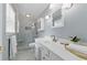 Updated bathroom with a walk-in shower, marble tile, and white vanity offers a spa-like experience at 4205 Jeri Lynn Ct, Tucker, GA 30084