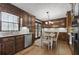 Kitchen with dark wood cabinets, stainless steel appliances, and dining nook at 4205 Jeri Lynn Ct, Tucker, GA 30084