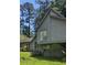Unique two-story home with gray siding, modern architectural details, and well-maintained landscaping at 4287 Ridgetop Trl, Ellenwood, GA 30294