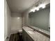 Bathroom featuring vanity with granite countertop, framed mirror, and shower-tub combo at 142 Tye St, Stockbridge, GA 30281