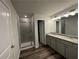 Primary bathroom features double vanity, walk-in shower, and granite counters at 142 Tye St, Stockbridge, GA 30281