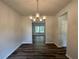 Dining room with wood flooring, modern chandelier, neutral walls and open to other rooms at 142 Tye St, Stockbridge, GA 30281