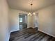 Dining room with wood flooring, modern chandelier, neutral walls and open to other rooms at 142 Tye St, Stockbridge, GA 30281