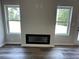 Modern electric fireplace flanked by windows with outdoor views at 142 Tye St, Stockbridge, GA 30281