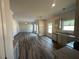 Open-concept kitchen with granite countertops, wood floors, stainless appliances, and ample natural light at 142 Tye St, Stockbridge, GA 30281