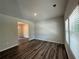 Open living room with wood flooring, large windows, and neutral walls, offering a bright and inviting space at 142 Tye St, Stockbridge, GA 30281