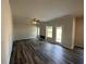Spacious living room with wood flooring, a fireplace, and natural light from the windows, creating an inviting atmosphere at 142 Tye St, Stockbridge, GA 30281