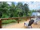 Back deck with a brown wood railing overlooks a lush green backyard and is a great outdoor space at 1744 Habershal Nw Dr, Atlanta, GA 30318