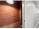 A basement with exposed brick wall leads to another floor in the house at 1744 Habershal Nw Dr, Atlanta, GA 30318