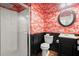 This bathroom features flamingo wallpaper, wood trim, a shower, and modern fixtures at 1744 Habershal Nw Dr, Atlanta, GA 30318
