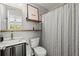Bathroom with floating shelves, a black vanity with gold hardware, and a shower at 1744 Habershal Nw Dr, Atlanta, GA 30318