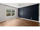 Bedroom with hardwood floors, a large window with a view, and an accent wall at 1744 Habershal Nw Dr, Atlanta, GA 30318