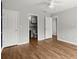 Bedroom featuring hardwood floors, a ceiling fan, and an en-suite bathroom at 1744 Habershal Nw Dr, Atlanta, GA 30318