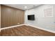 This bedroom features a decorative wood accent wall and hardwood flooring with a mounted TV at 1744 Habershal Nw Dr, Atlanta, GA 30318