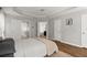 Bedroom featuring a neutral palette, hardwood floors, tray ceiling, and access to an en-suite bathroom at 1744 Habershal Nw Dr, Atlanta, GA 30318