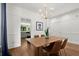 Elegant dining room with hardwood floors, wainscoting, and modern lighting at 1744 Habershal Nw Dr, Atlanta, GA 30318