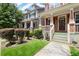 Townhome exterior showcasing landscaped front yard, porch, and craftsman-style architecture at 1744 Habershal Nw Dr, Atlanta, GA 30318