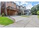 View of townhomes with driveways and a three-level deck in a well manicured community at 1744 Habershal Nw Dr, Atlanta, GA 30318