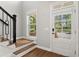 Welcoming foyer with hardwood floors, staircase, and natural light streaming through the front door at 1744 Habershal Nw Dr, Atlanta, GA 30318