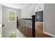 Bright hallway with modern railing, wood floors, and natural light at 1744 Habershal Nw Dr, Atlanta, GA 30318