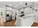 Charming kitchen features stainless steel appliances, granite countertops, and white cabinets at 1744 Habershal Nw Dr, Atlanta, GA 30318