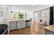 Open-concept kitchen featuring granite countertops, stainless steel appliances, and seamless flow to living area at 1744 Habershal Nw Dr, Atlanta, GA 30318