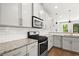 Modern kitchen with stainless steel appliances, gray cabinets, and granite countertops at 1744 Habershal Nw Dr, Atlanta, GA 30318