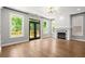 Open living room with fireplace, hardwood floors, and doors leading to a deck at 1744 Habershal Nw Dr, Atlanta, GA 30318