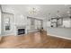 Open concept living room featuring a modern fireplace and stylish lighting fixtures at 1744 Habershal Nw Dr, Atlanta, GA 30318