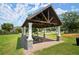 A covered picnic area with stone accents and a table for gatherings and outdoor enjoyment at 1744 Habershal Nw Dr, Atlanta, GA 30318