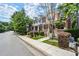 Serene neighborhood street view with townhomes and mature trees lining the sidewalks at 1744 Habershal Nw Dr, Atlanta, GA 30318