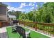 Relaxing back deck with artificial turf, a grill, comfortable seating, and tree views, ideal for outdoor entertaining at 1744 Habershal Nw Rd, Atlanta, GA 30318