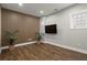 Finished basement with a modern accent wall, recessed lighting, hardwood floors, and a wall-mounted TV at 1744 Habershal Nw Rd, Atlanta, GA 30318
