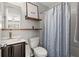 Bathroom with a modern vanity, open shelving, and a shower-tub combination with a patterned curtain at 1744 Habershal Nw Rd, Atlanta, GA 30318
