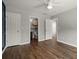 Comfortable bedroom showcasing hardwood floors, multiple doors, a ceiling fan and neutral paint at 1744 Habershal Nw Rd, Atlanta, GA 30318