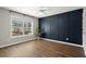 Bright bedroom with a feature wall, hardwood floors, a ceiling fan and a large window overlooking the yard at 1744 Habershal Nw Rd, Atlanta, GA 30318