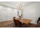 Dining room with statement lighting, wainscoting, modern wood table and seating, and beautiful hardwood floors at 1744 Habershal Nw Rd, Atlanta, GA 30318