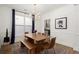 Stylish dining room with a modern chandelier, wooden table, and wainscoting at 1744 Habershal Nw Rd, Atlanta, GA 30318
