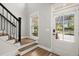 Bright entryway featuring stairs with sleek black railings and a sunlit front door at 1744 Habershal Nw Rd, Atlanta, GA 30318