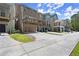 A row of townhomes showcasing their rear exteriors, driveways, and varied deck designs at 1744 Habershal Nw Rd, Atlanta, GA 30318