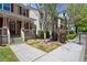 Charming front exterior of multi-story townhomes with lush landscaping and sidewalks at 1744 Habershal Nw Rd, Atlanta, GA 30318