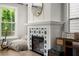 Stylish fireplace with star patterned tile, white mantel, gold mirror, and musical instruments adding warmth to the living space at 1744 Habershal Nw Rd, Atlanta, GA 30318